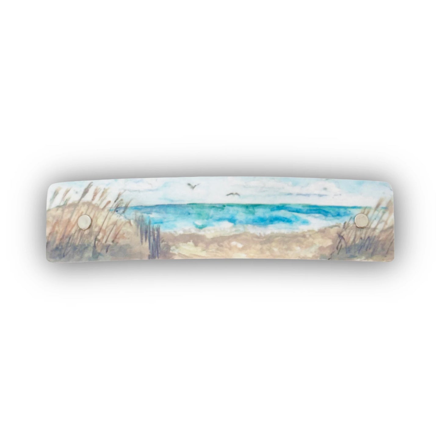 Boutique hair clip featuring original watercolor artwork by Robbin V. Davis Studio of a sandy shore, blue ocean waves, and a pale sky. 