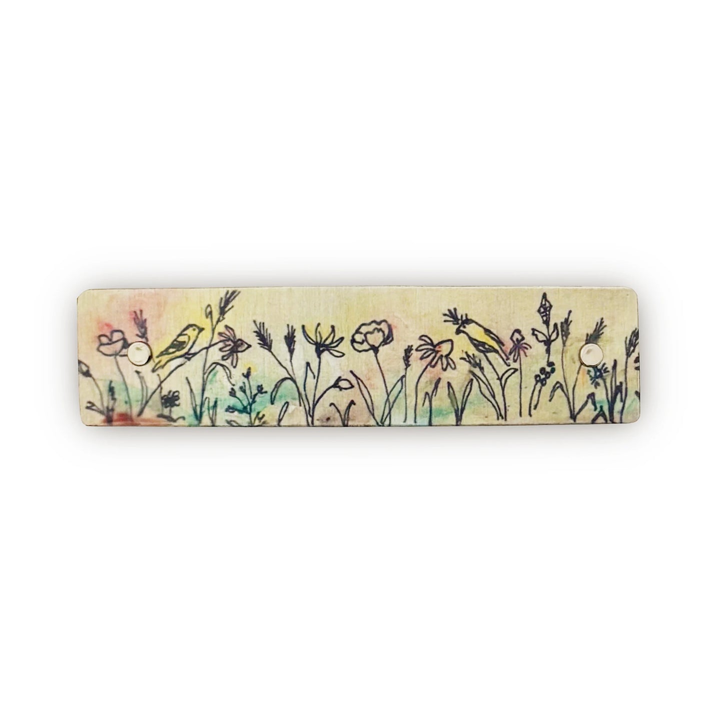 A boutique hair barrette featuring a hand-drawn style illustration of wildflowers and two small birds in soft pastel colors on a light beige background, shown against a plain white backdrop.