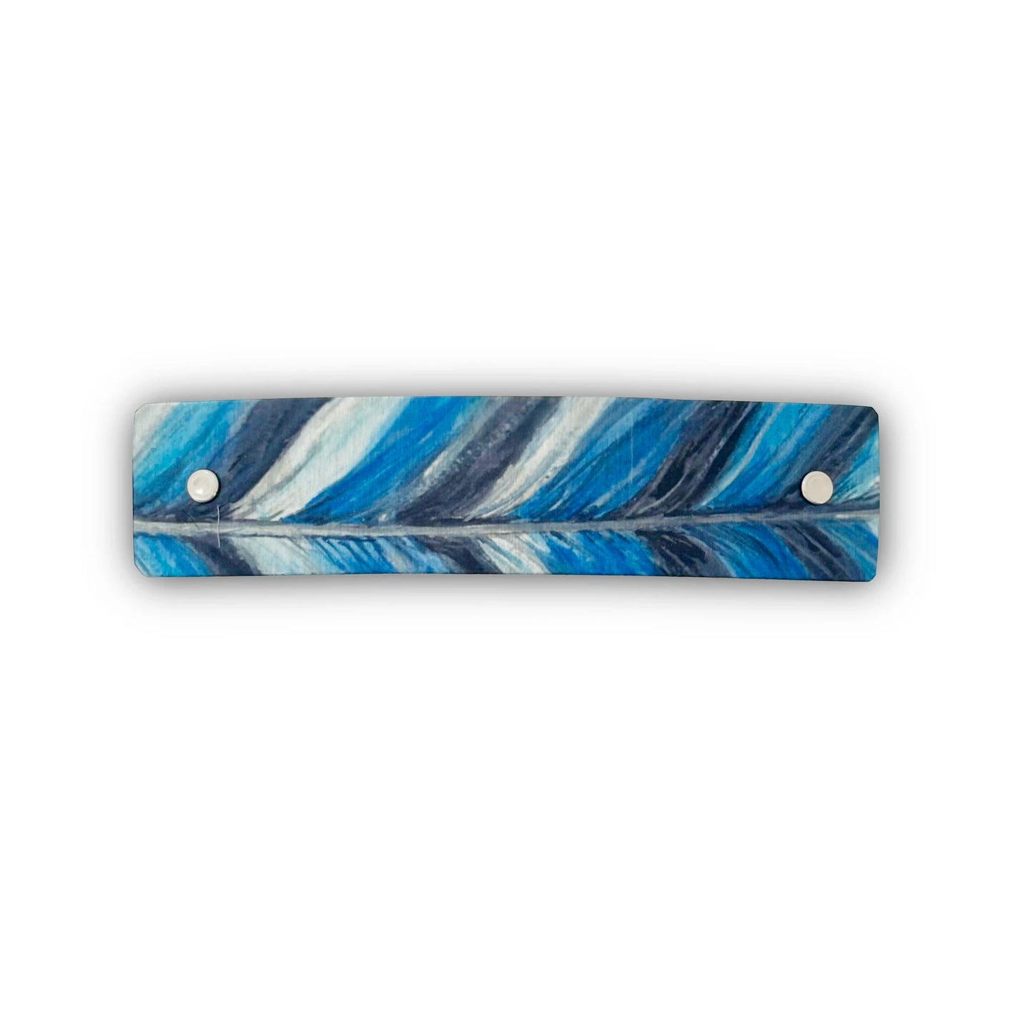 A rectangular barrette with rounded corners featuring a blue, white, and navy feather pattern, secured with two silver metal rivets on a white background.