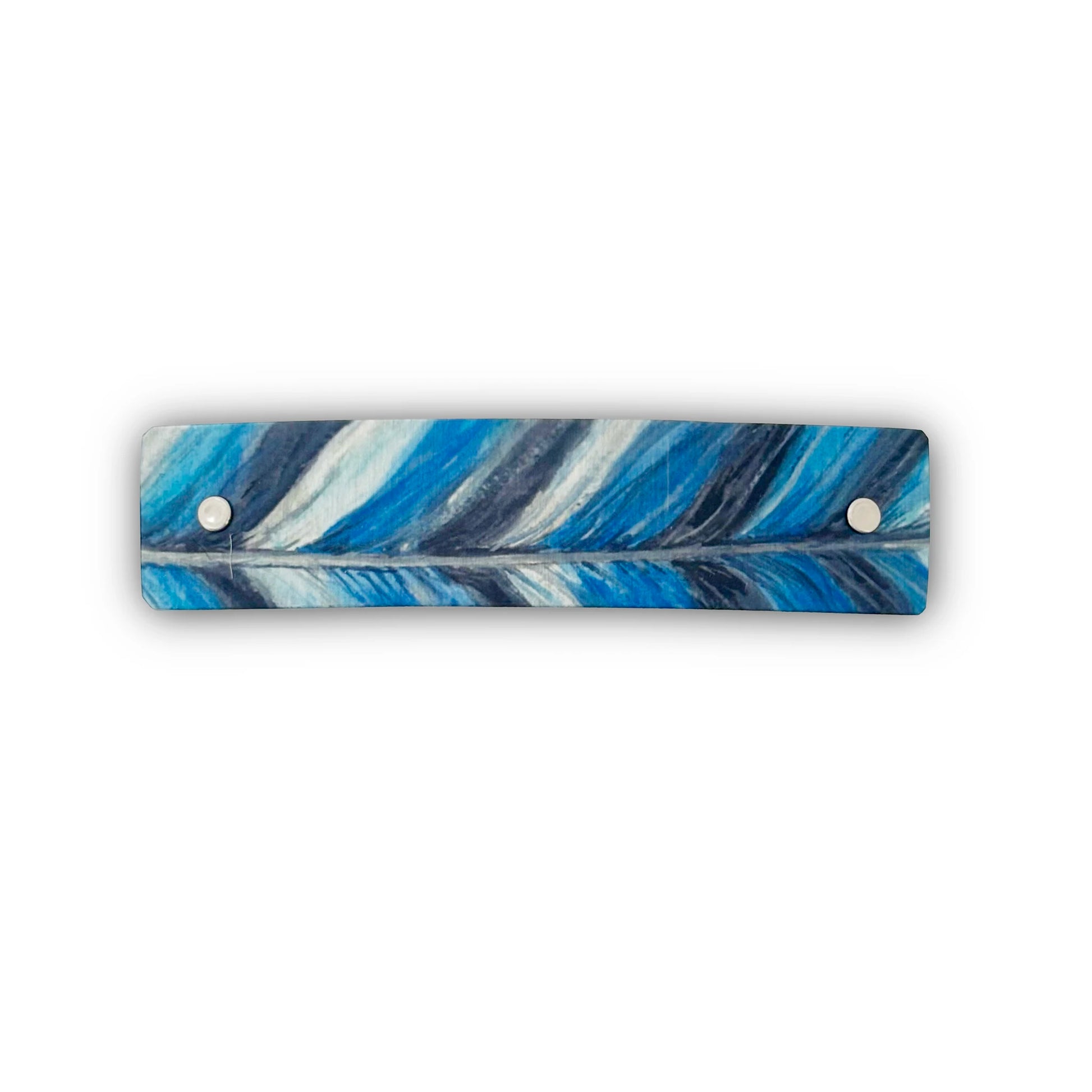 A rectangular barrette with rounded corners featuring a blue, white, and navy feather pattern, secured with two silver metal rivets on a white background.