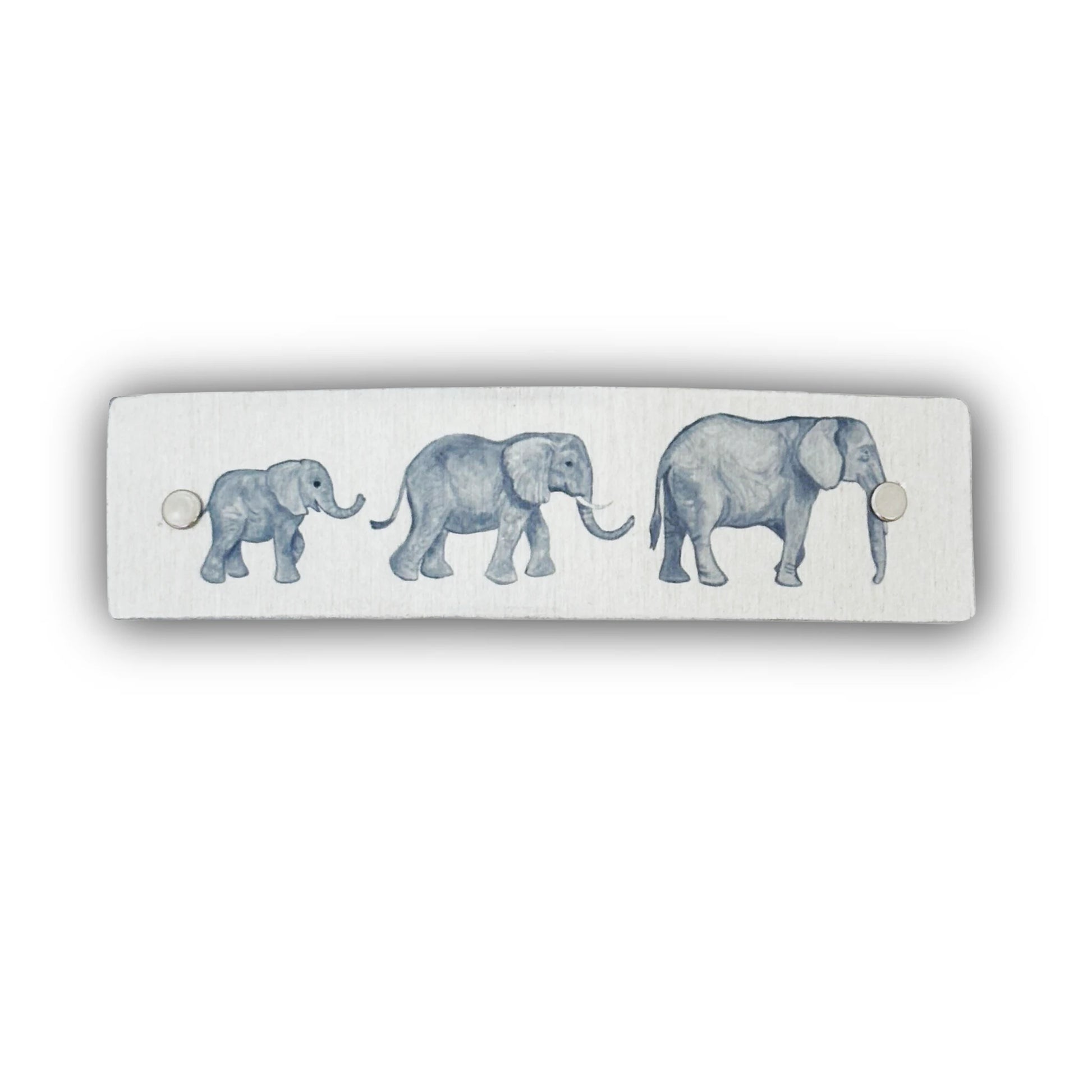 A handmade silver metal barrette with a watercolor-style print of three elephants in shades of blue-gray.
