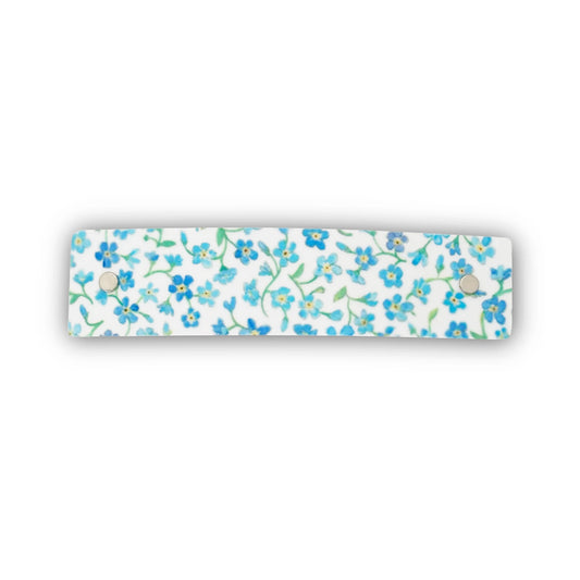 Hair clip decorated with original watercolor artwork of a dainty blue floral design.