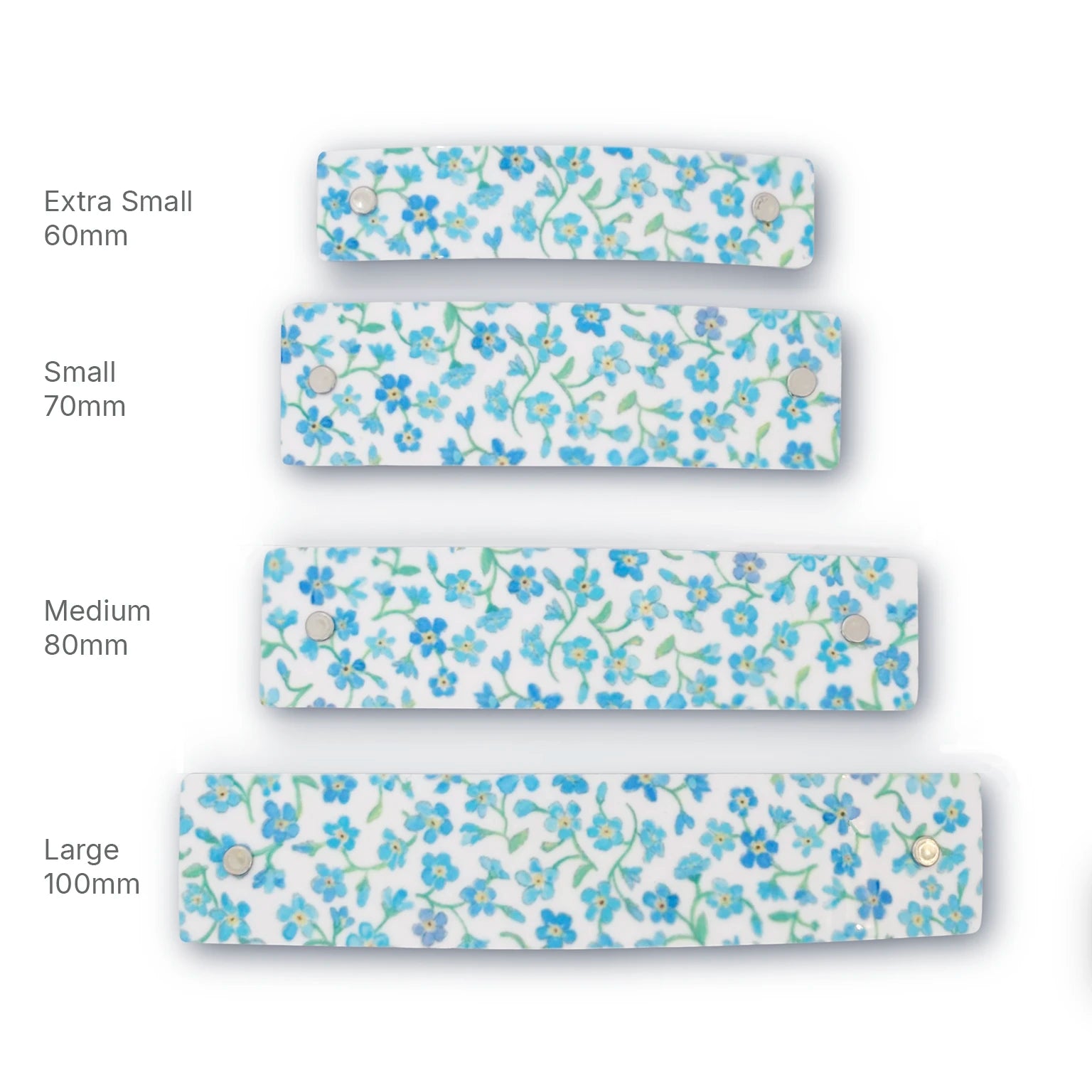 Four French barrette hair clips with a blue and green forget-me-not floral pattern on a white background, shown in sizes Extra Small 60mm, Small 70mm, Medium 80mm, and Large 100mm, arranged vertically with size labels.