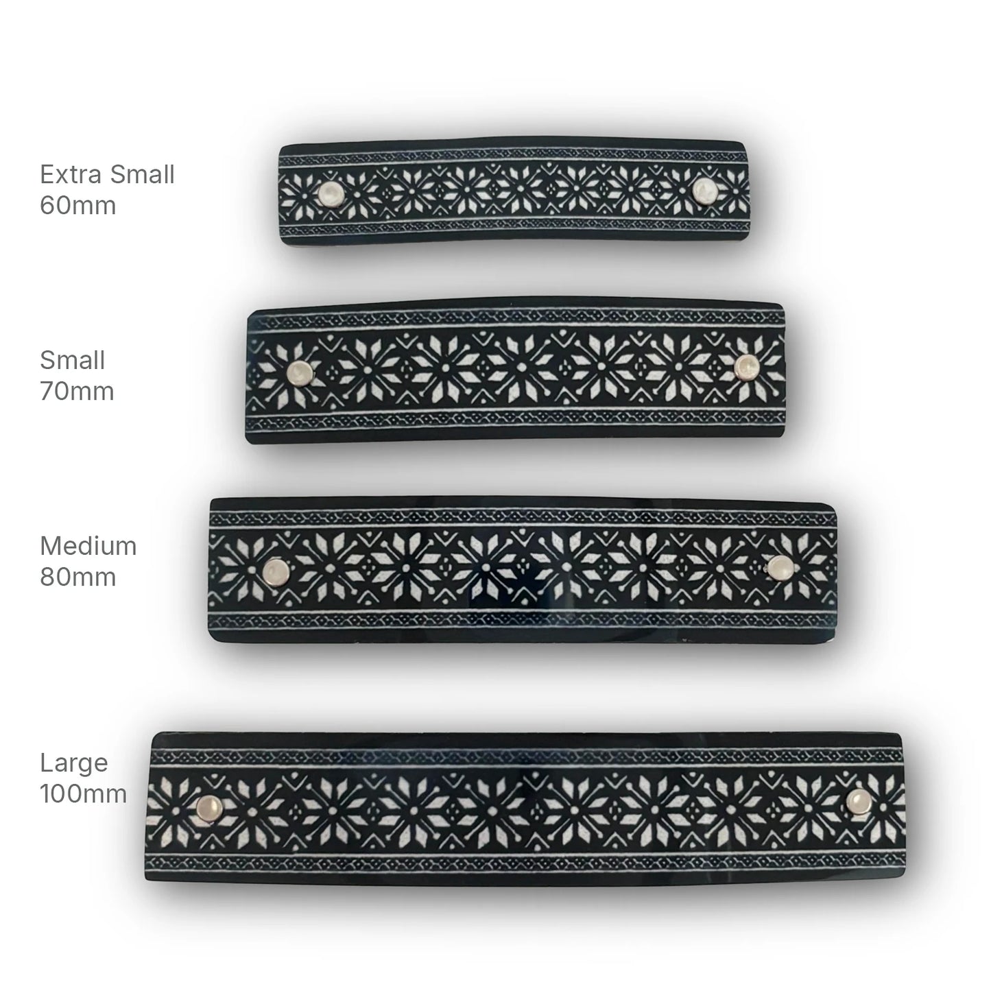 Four black hair clips with silver snowflake stars,, shown in sizes Extra Small 60mm, Small 70mm, Medium 80mm, and Large 100mm on a white background with size labels. 