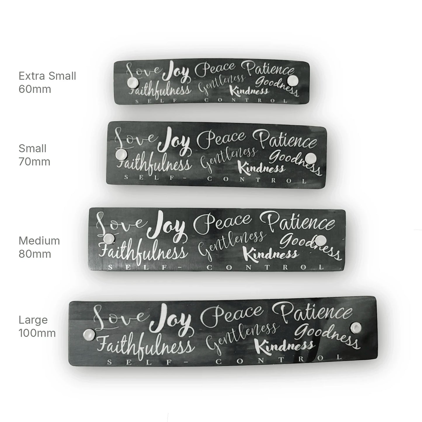 Four rectangular dark gray hair clip barrettes with silver hand-lettered text reading 'Love Joy Peace Patience Faithfulness Gentleness Goodness Kindness SELF CONTROL,' shown in extra small, small, medium, and large sizes on a white background with size labels.