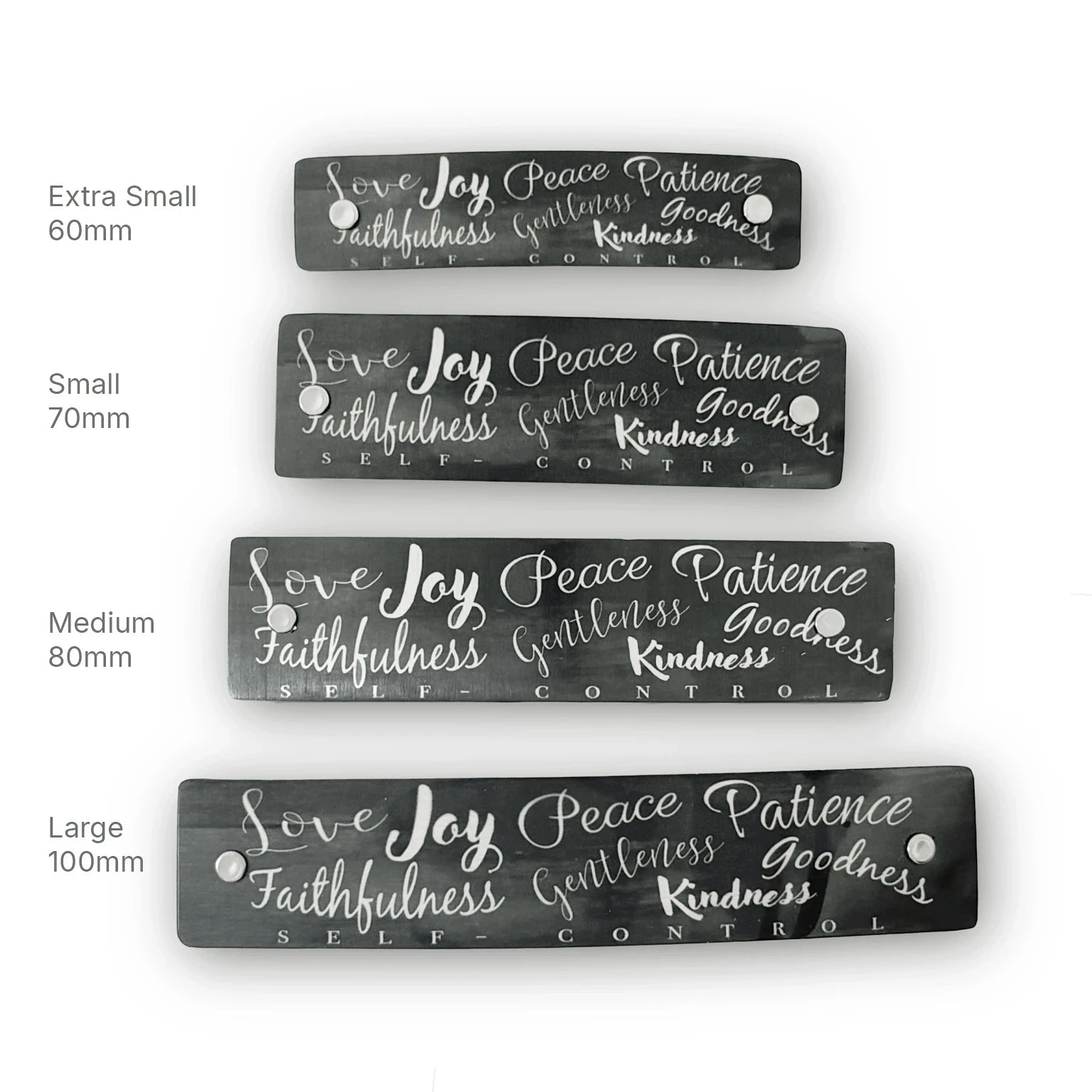 Four rectangular dark gray hair clip barrettes with silver hand-lettered text reading 'Love Joy Peace Patience Faithfulness Gentleness Goodness Kindness SELF CONTROL,' shown in extra small, small, medium, and large sizes on a white background with size labels.