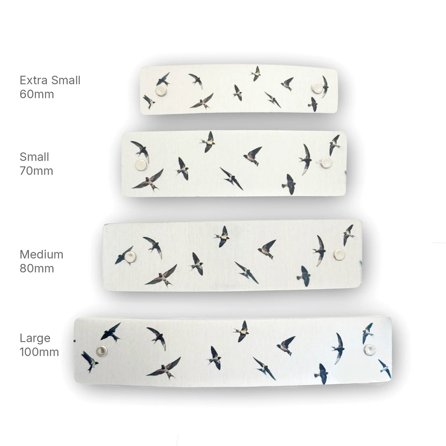 Four silver hair barrettes shown in different sizes (Extra Small 60mm, Small 70mm, Medium 80mm, Large 100mm) with a flying swallows bird pattern, arranged vertically on a white background with size labels.