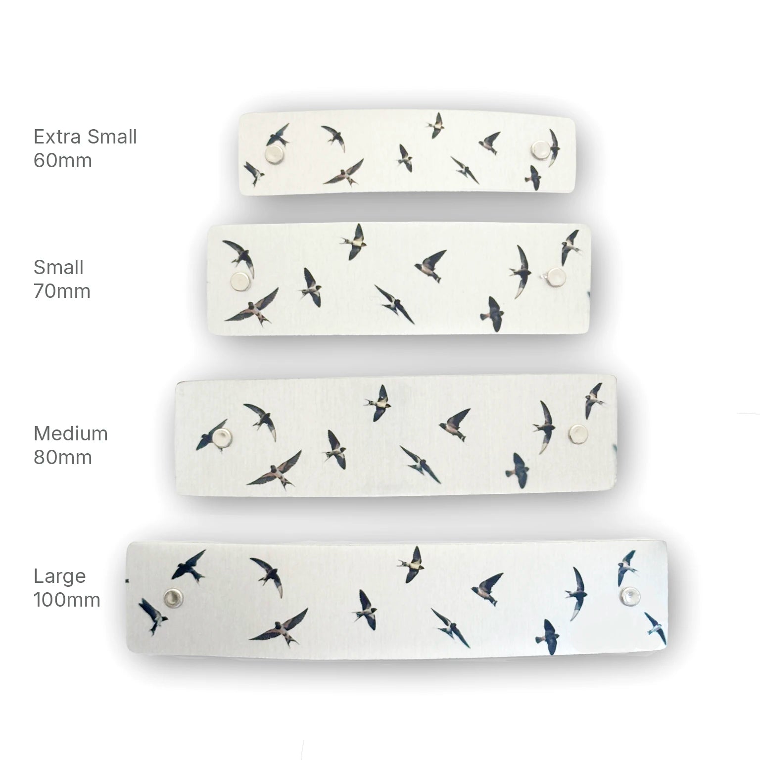 Four silver hair barrettes shown in different sizes (Extra Small 60mm, Small 70mm, Medium 80mm, Large 100mm) with a flying swallows bird pattern, arranged vertically on a white background with size labels.