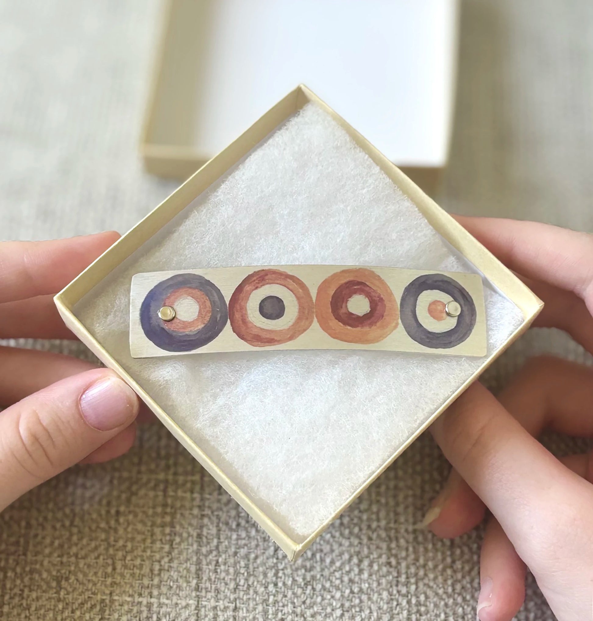 Handmade boutique metal hair clip in soft earth tones, fall hair accessory, handmade by Robbin V. Davis Studio, shown presented in a square gift box.