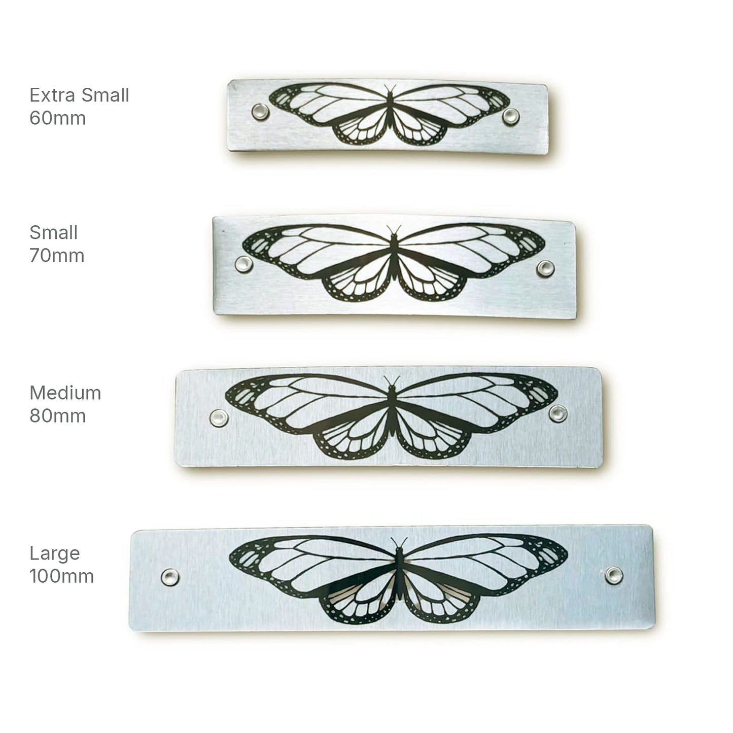 Four metal hair barrettes, with original artwork by Robbin V. Davis Studio, in four sizes.