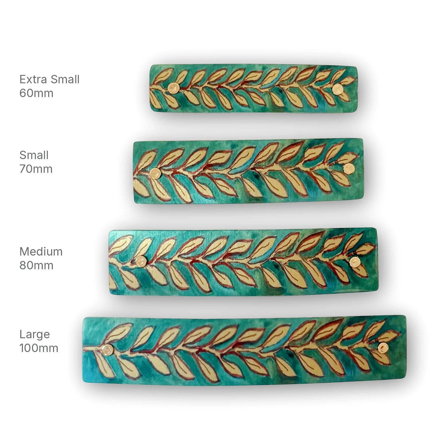 Four rectangular decorative hair clips shown in different sizes labeled Extra Small 60mm, Small 70mm, Medium 80mm, and Large 100mm. The clips have a turquoise-green background with a  leaf pattern in gold and brown, and small gold-tone metal rivets at the ends.