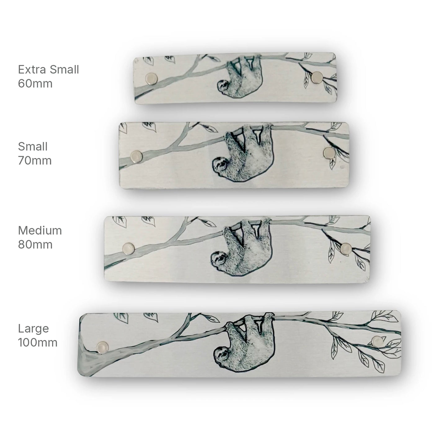 Four rectangular metal hair clips in different sizes (Extra Small 60mm, Small 70mm, Medium 80mm, Large 100mm) lined up vertically on a white background. Each barrette features a black line drawn illustration of a sloth hanging from a tree branch.