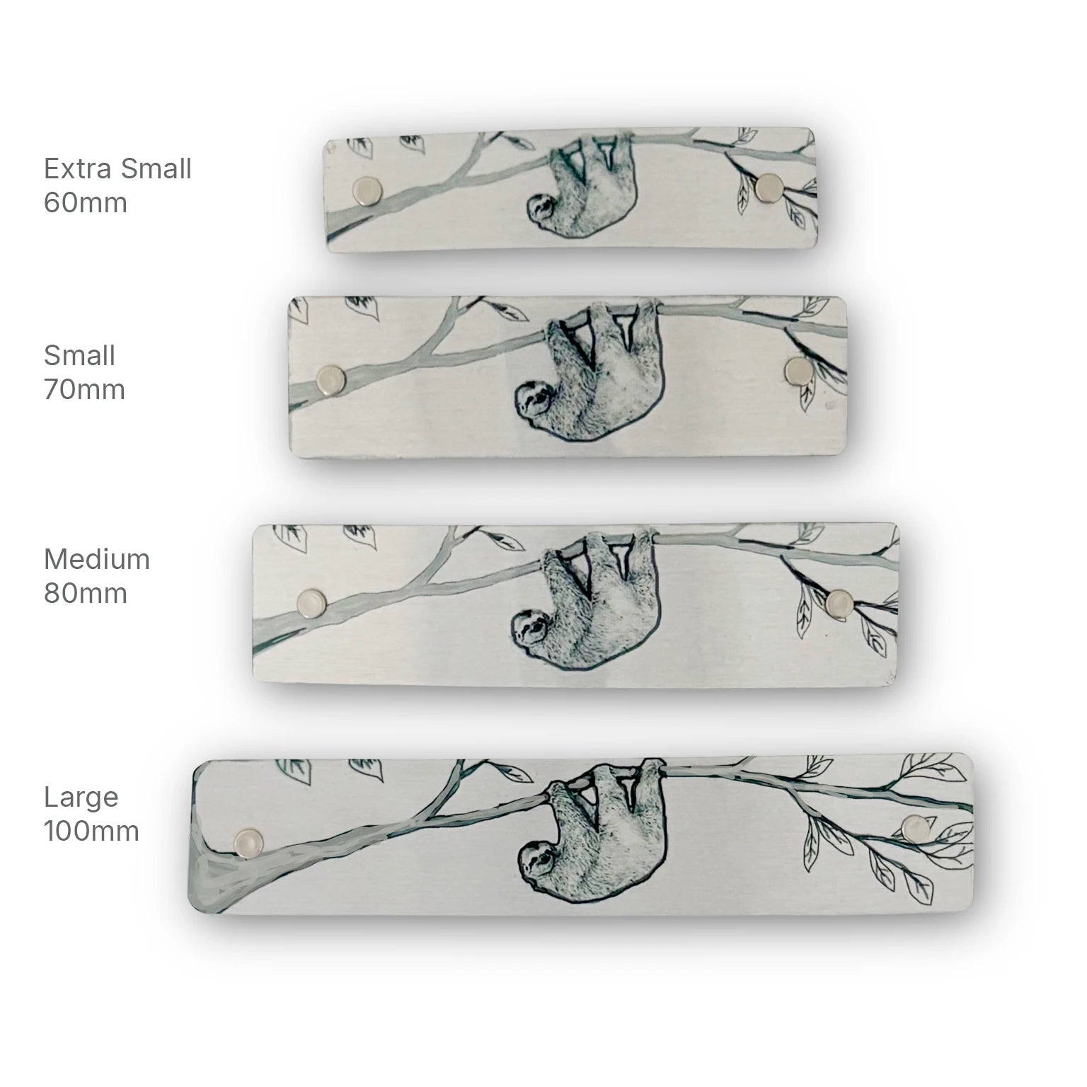 Four rectangular metal hair clips in different sizes (Extra Small 60mm, Small 70mm, Medium 80mm, Large 100mm) lined up vertically on a white background. Each barrette features a black line drawn illustration of a sloth hanging from a tree branch.