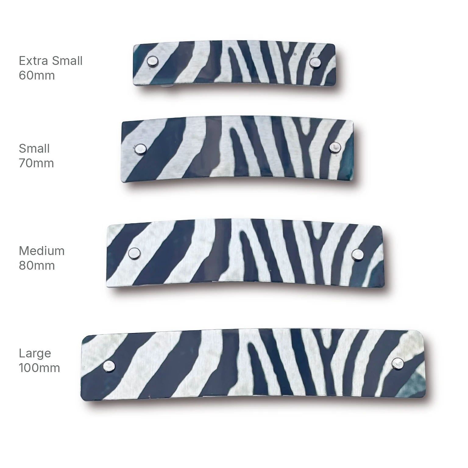Four zebra-print hair clips shown in different sizes (Extra Small 60mm, Small 70mm, Medium 80mm, Large 100mm) on a white background with size labels.