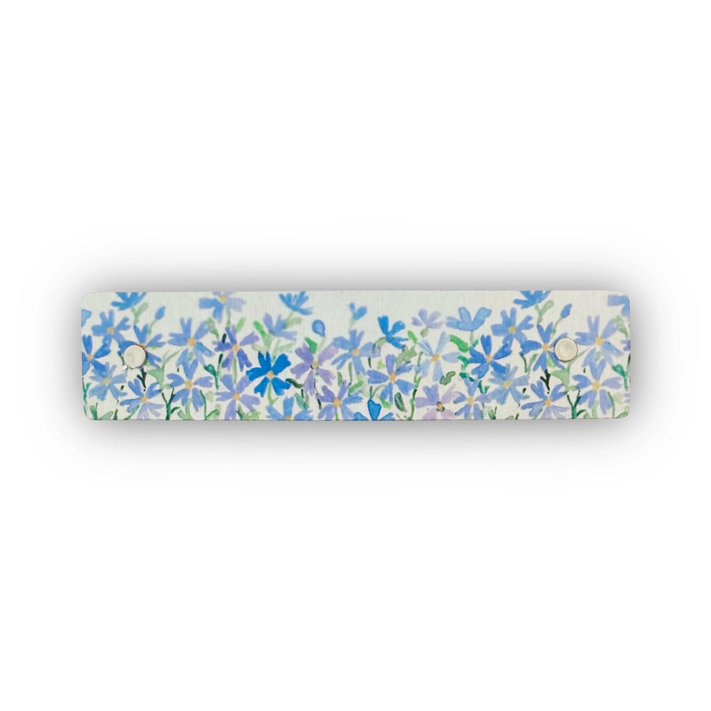 A rectangular silver hair clip featuring a dense watercolor-style floral pattern of blue and purple flowers with green stems, shown against a plain white background.