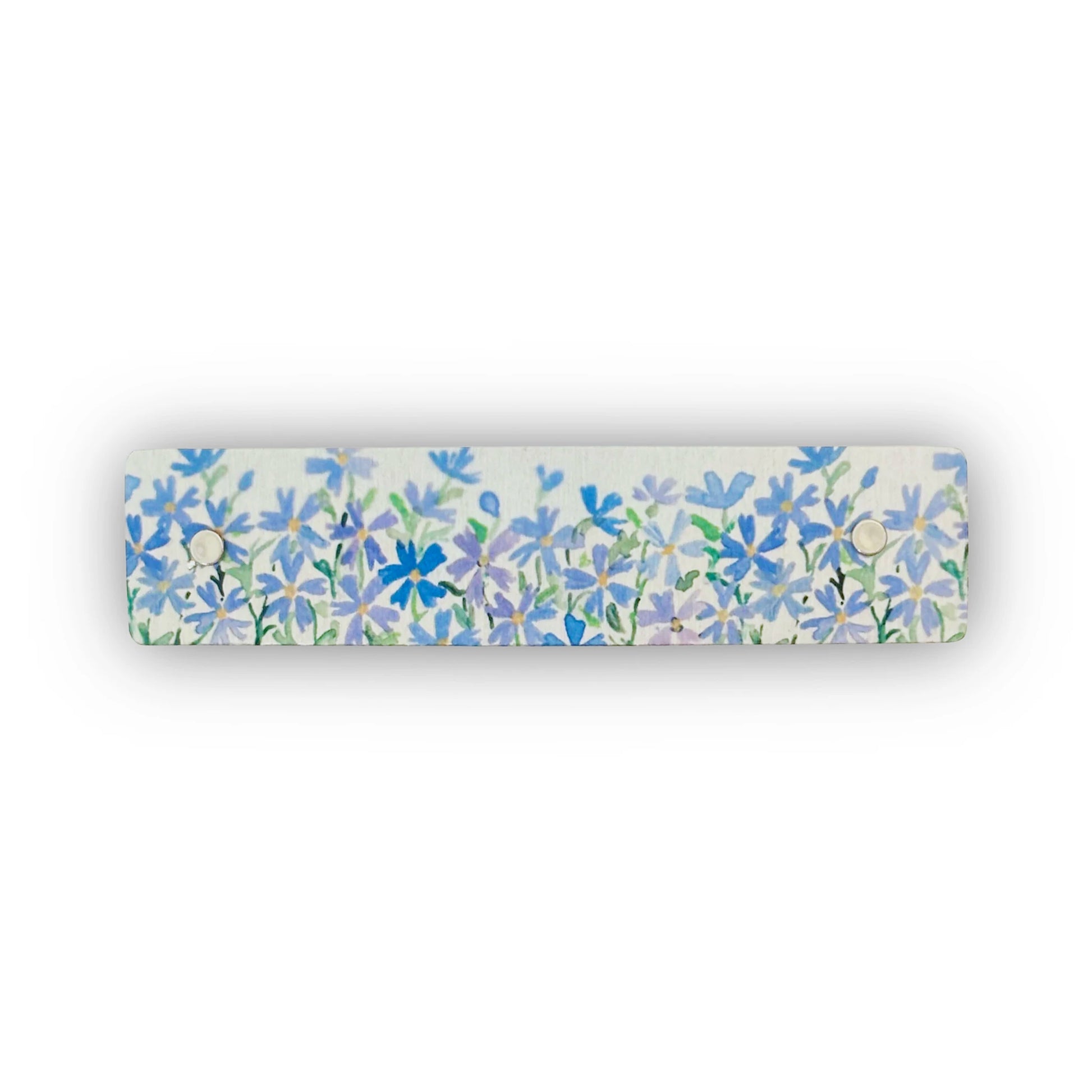 A rectangular silver hair clip featuring a dense watercolor-style floral pattern of blue and purple flowers with green stems, shown against a plain white background.
