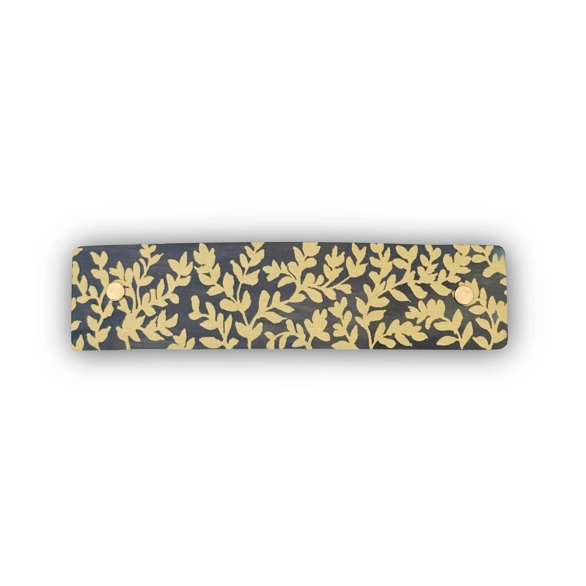  A boutique handmade French barrette with rounded corners featuring a delicate gold leaf pattern on a dark charcoal gray background, shown against a plain white background.