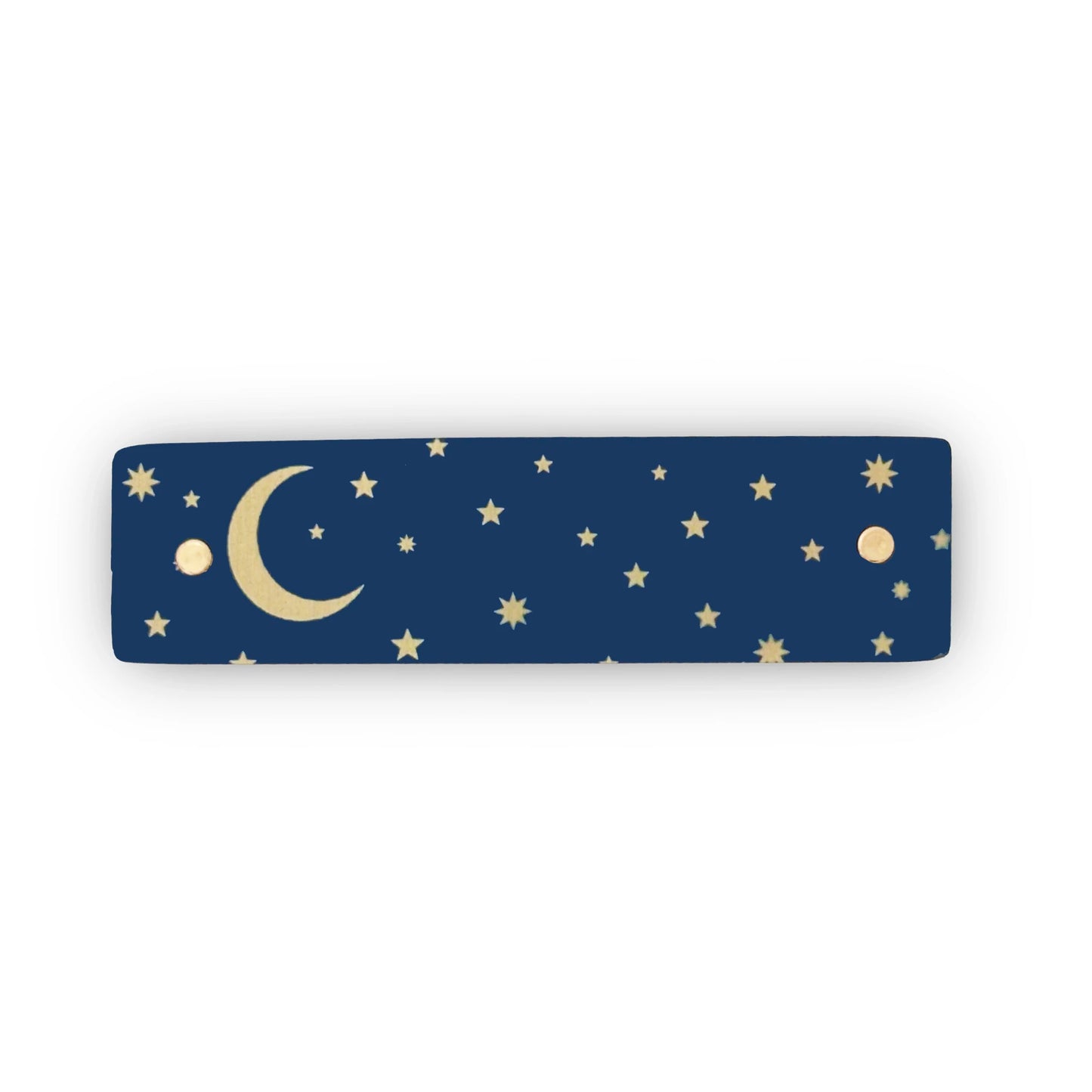A gold crescent moon and tiny gold stars against a dark blue background adorn this boutique, handmade hair clip by Robbin V. Davis Studio.