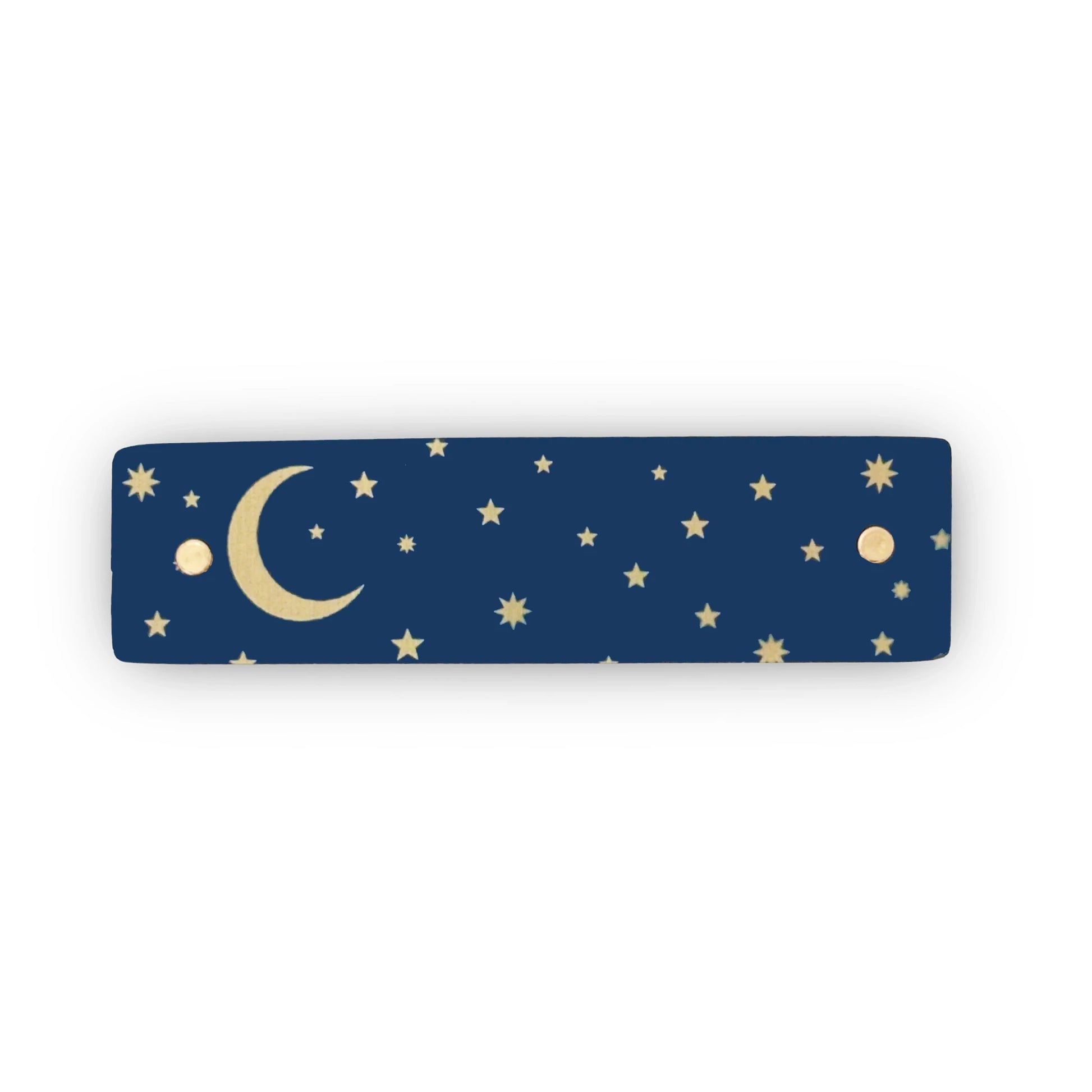 A gold crescent moon and tiny gold stars against a dark blue background adorn this boutique, handmade hair clip by Robbin V. Davis Studio.
