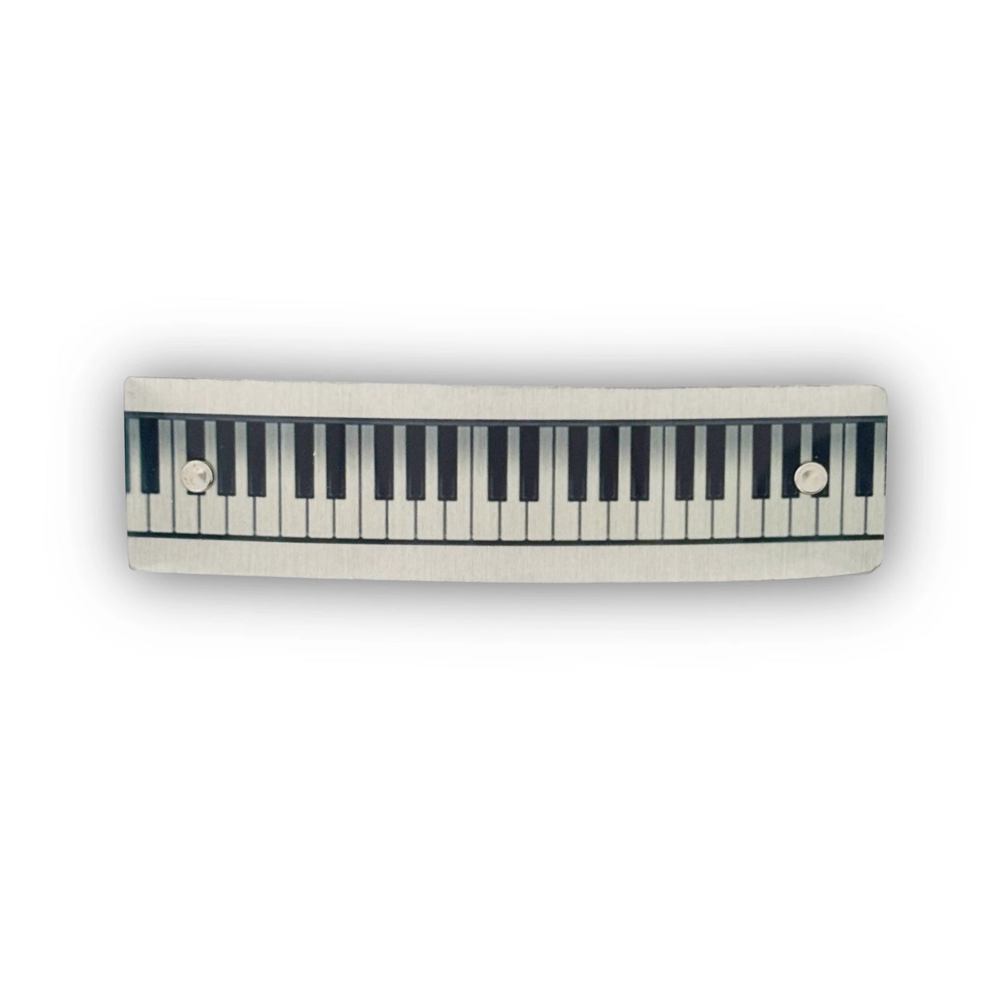 A handmade hair barrette with a piano keyboard design, by Robbin V. Davis Studio.