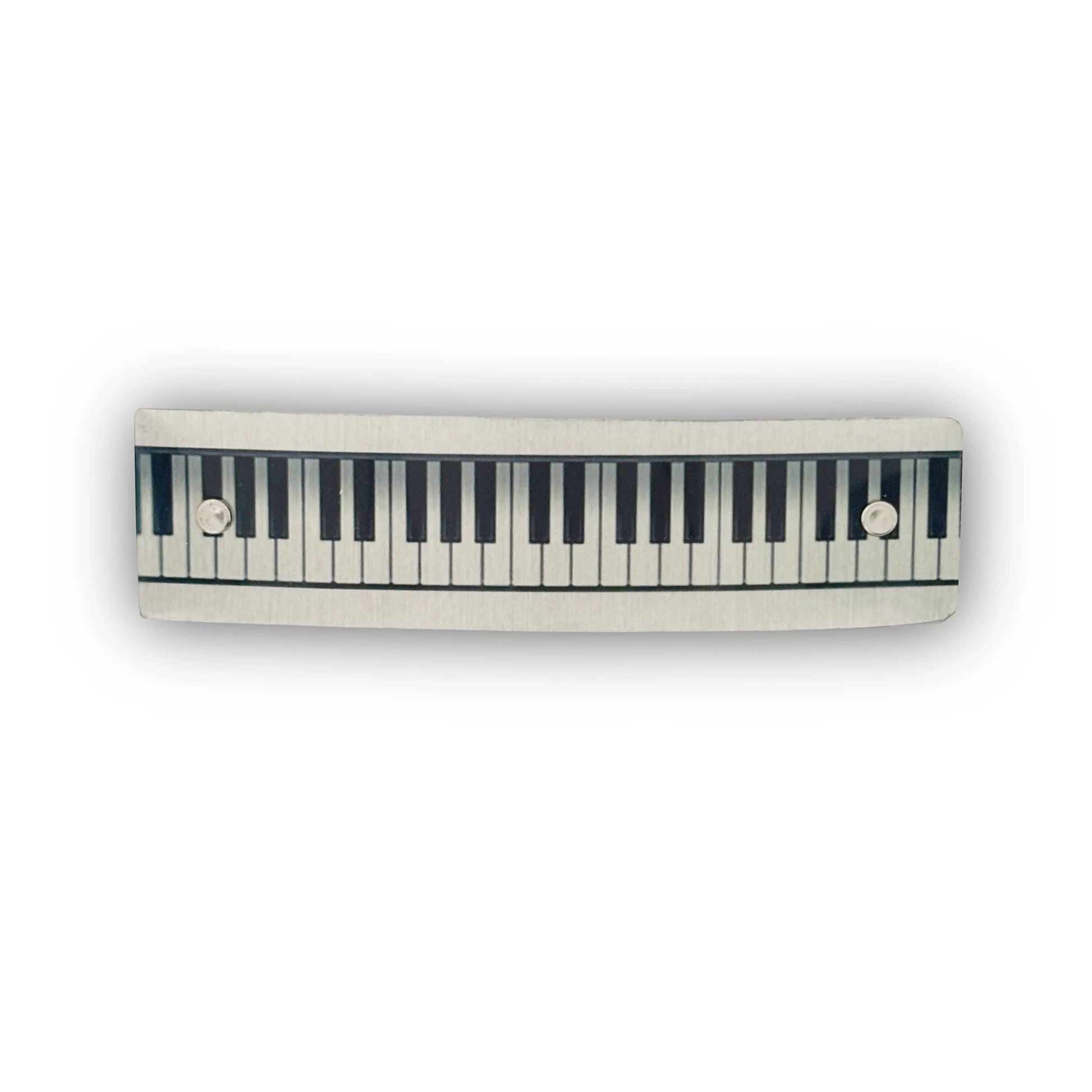 A handmade hair barrette with a piano keyboard design, by Robbin V. Davis Studio.