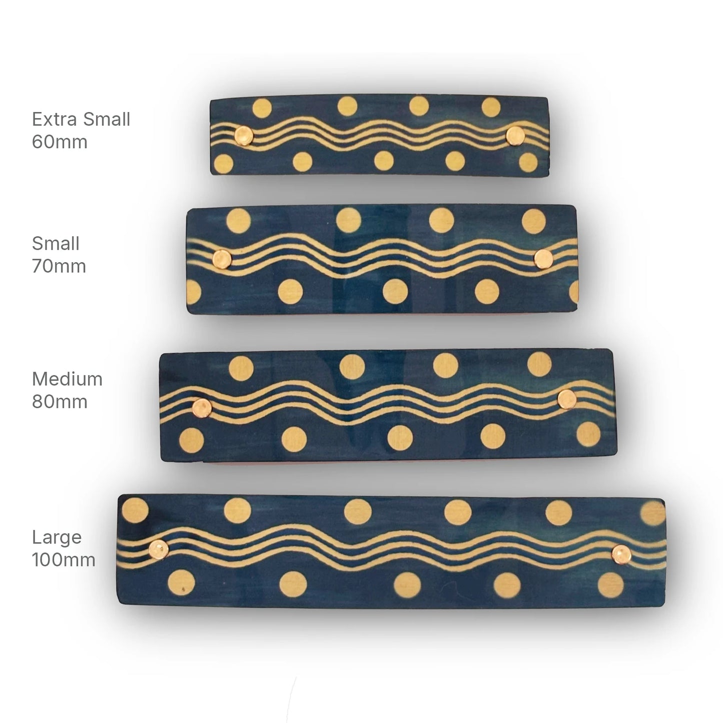 Four rectangular dark gray- blue hair barrettes with gold wavy lines and gold dots, shown in sizes Extra Small 60mm, Small 70mm, Medium 80mm, and Large 100mm on a white background.