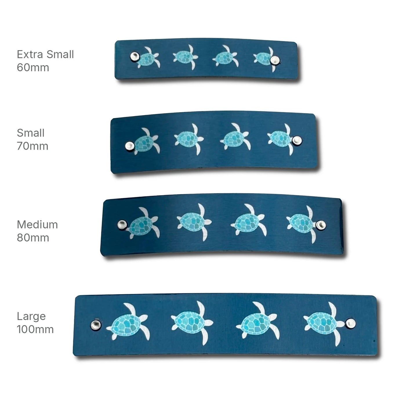 Four navy blue metal hair barrette clips with a repeating sea turtle pattern in light blue and silver, shown in sizes Extra Small 60mm, Small 70mm, Medium 80mm, and Large 100mm on a white background.