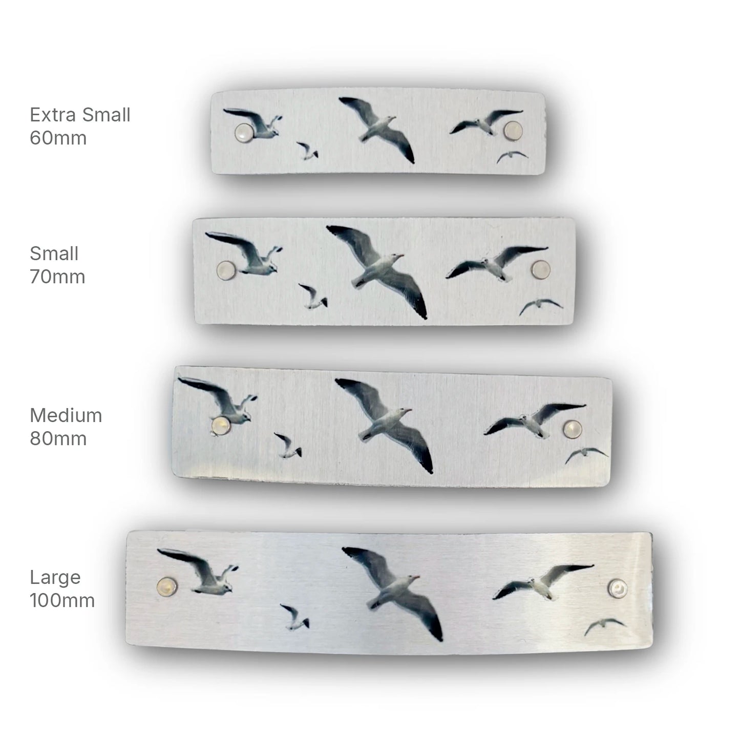 Four sizes of seagull hair clips, handmade in North Carolina.