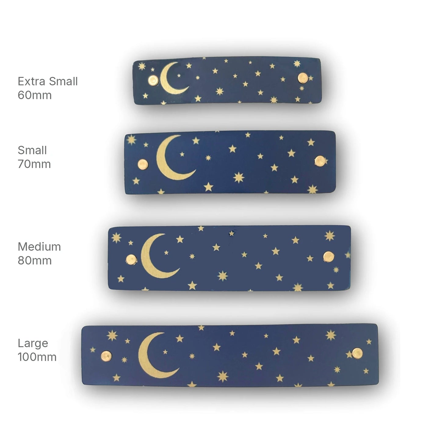 Four rectangular navy blue hair barrettes with a gold celestial pattern of crescent moons and stars, shown in sizes Extra Small 60mm, Small 70mm, Medium 80mm, and Large 100mm on a white background.