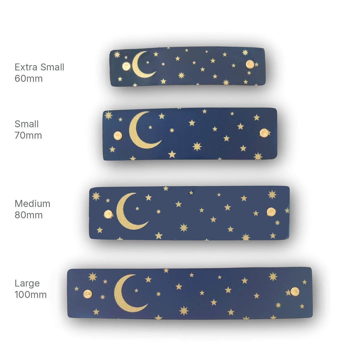 Four rectangular navy blue hair barrettes with a gold celestial pattern of crescent moons and stars, shown in sizes Extra Small 60mm, Small 70mm, Medium 80mm, and Large 100mm on a white background.