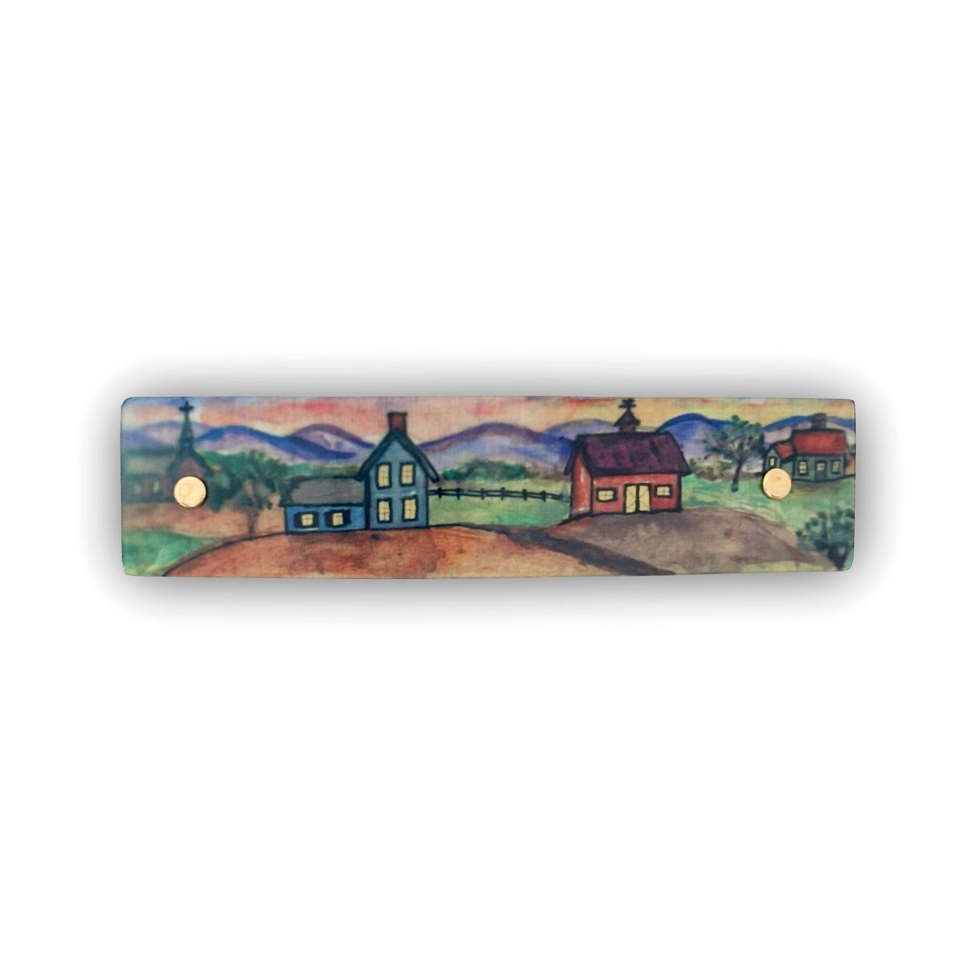 A rectangular hair clip featuring a hand-painted folk art landscape with houses, mountains, and trees, shown against a plain white background.