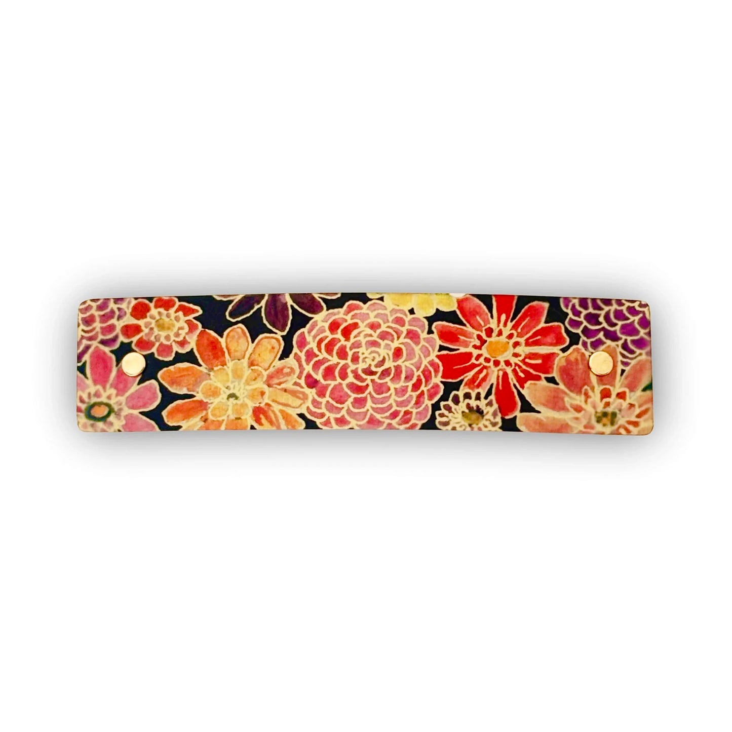 A rectangular barrette with rounded corners featuring a vibrant floral pattern in shades of red, orange, pink, yellow, and purple on a dark background, shown against a plain white background.